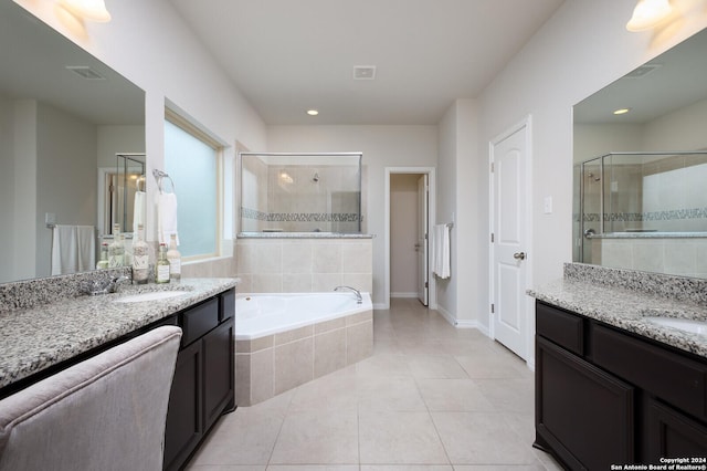 bathroom featuring tile patterned flooring, vanity, and separate shower and tub