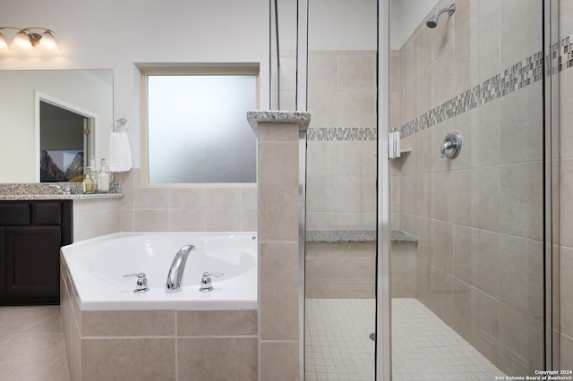 bathroom with independent shower and bath, vanity, and tile patterned flooring