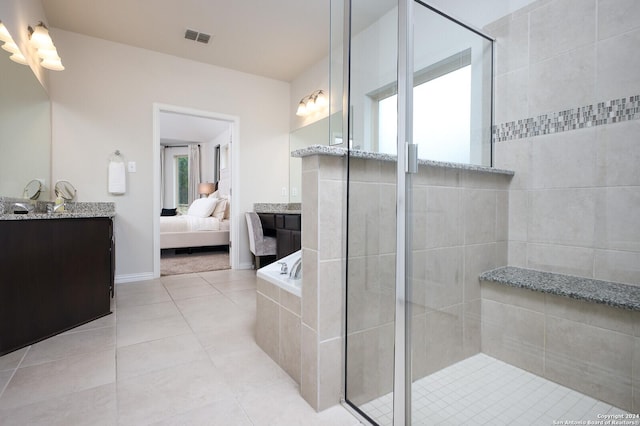 bathroom featuring tile patterned floors, independent shower and bath, and vanity