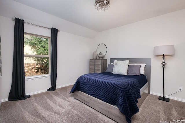 carpeted bedroom with vaulted ceiling