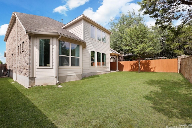 view of property exterior featuring a yard and central AC