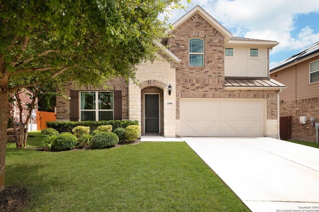 view of front of home with a garage and a front lawn