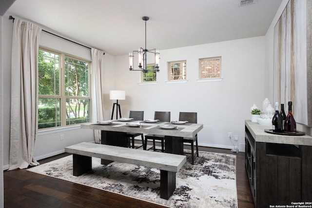 dining room featuring dark hardwood / wood-style flooring and a notable chandelier