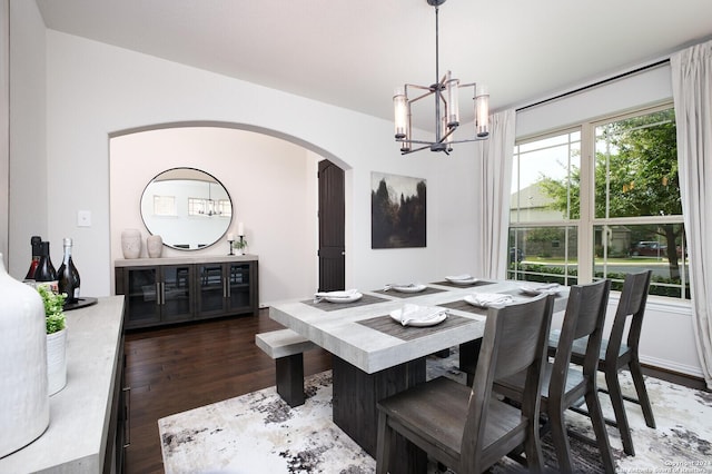 dining space with an inviting chandelier and dark hardwood / wood-style floors