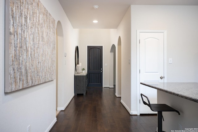 corridor with dark wood-type flooring