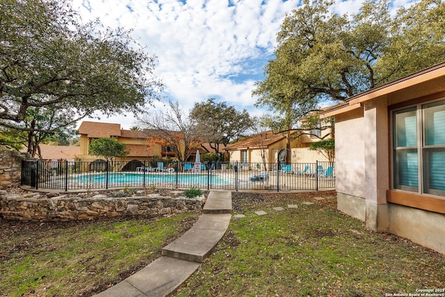 view of swimming pool featuring a lawn