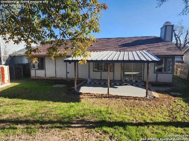 rear view of property with a patio area, a lawn, and fence