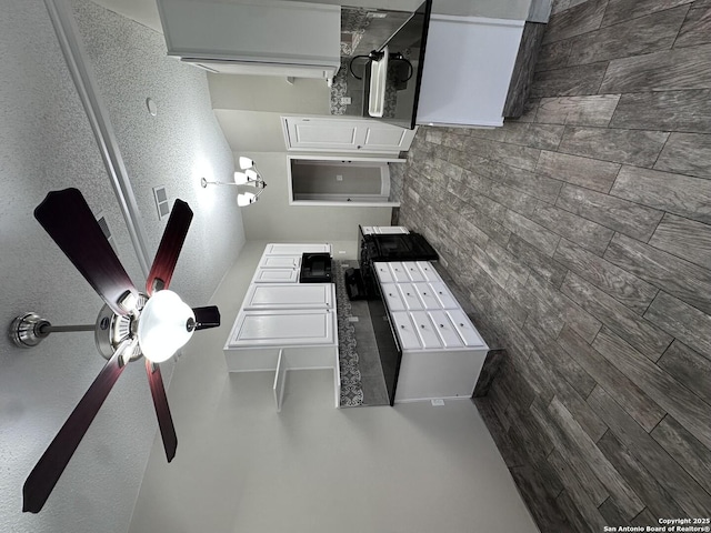 kitchen with white cabinetry and mail area