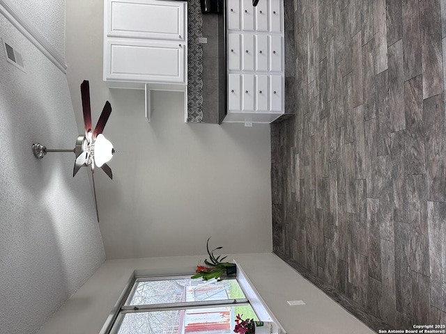 interior space featuring mail area, visible vents, white cabinets, and light countertops