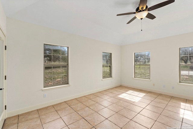 tiled spare room with ceiling fan