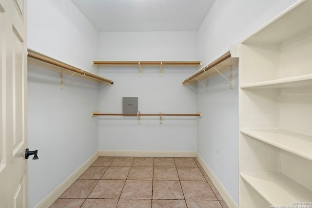 walk in closet with light tile patterned flooring and electric panel