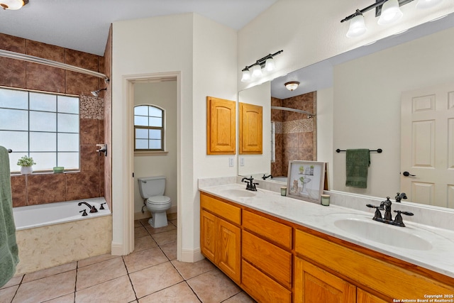 bathroom with tile patterned flooring, vanity, and toilet