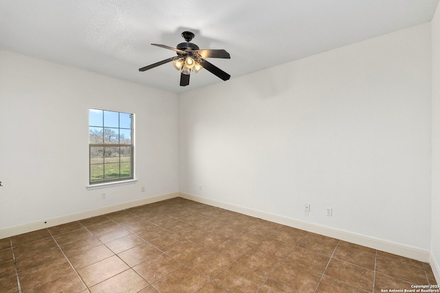 tiled empty room with ceiling fan