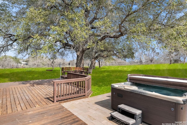 deck with a hot tub and a yard