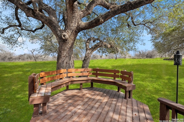 wooden deck featuring a yard