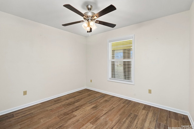 empty room with dark wood-type flooring and ceiling fan