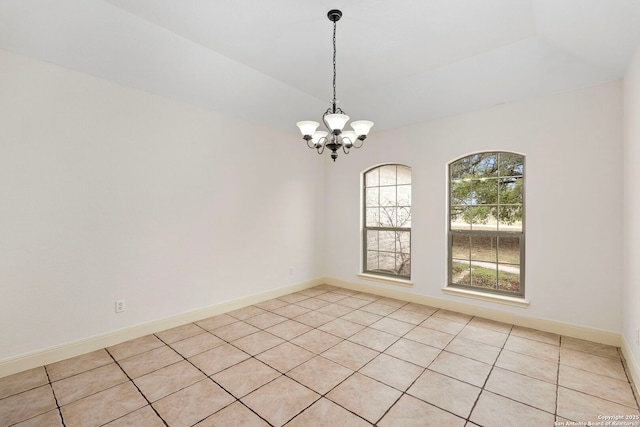 unfurnished room with a notable chandelier