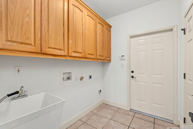 laundry area featuring light tile patterned flooring, sink, cabinets, hookup for a washing machine, and electric dryer hookup