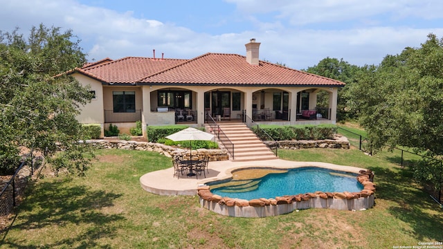 back of house featuring a yard and a patio