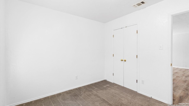 unfurnished bedroom with carpet floors and a closet