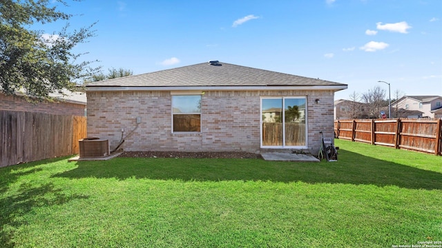 back of property featuring cooling unit and a lawn