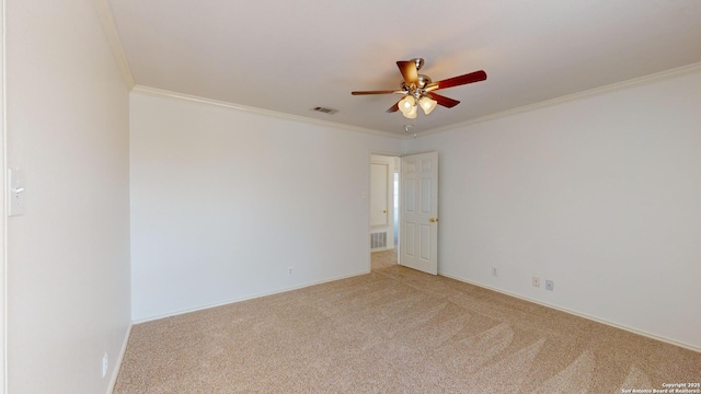 carpeted spare room with ornamental molding and ceiling fan