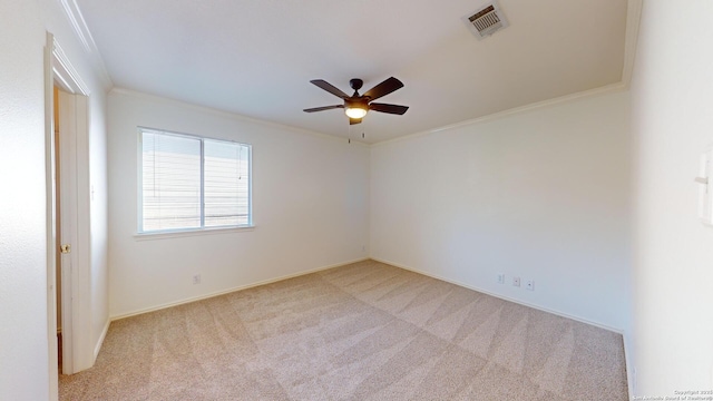 carpeted empty room with ornamental molding and ceiling fan