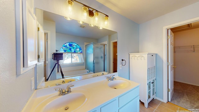 bathroom featuring independent shower and bath, vanity, and tile patterned flooring