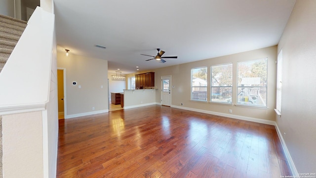 unfurnished living room with ceiling fan and dark hardwood / wood-style flooring