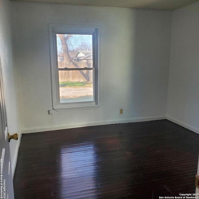 empty room with dark wood-type flooring