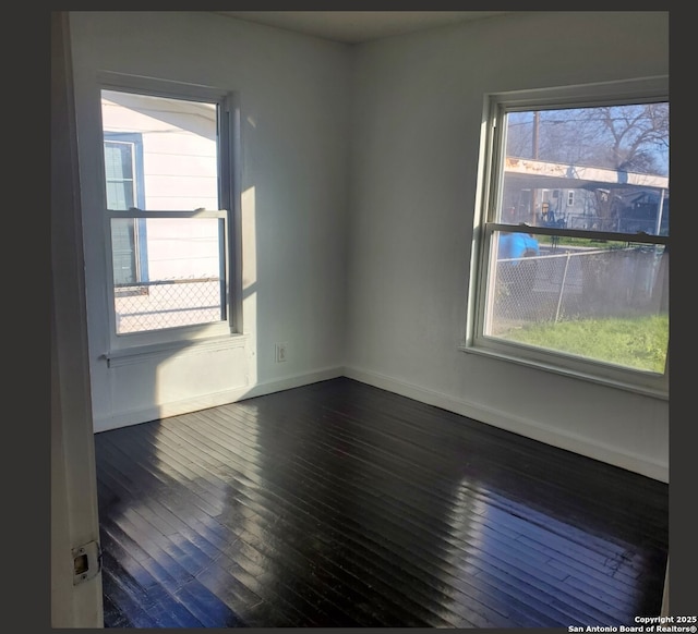 empty room featuring dark hardwood / wood-style flooring