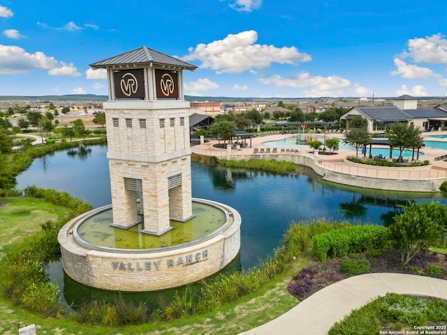 view of property's community featuring a water view and a swimming pool