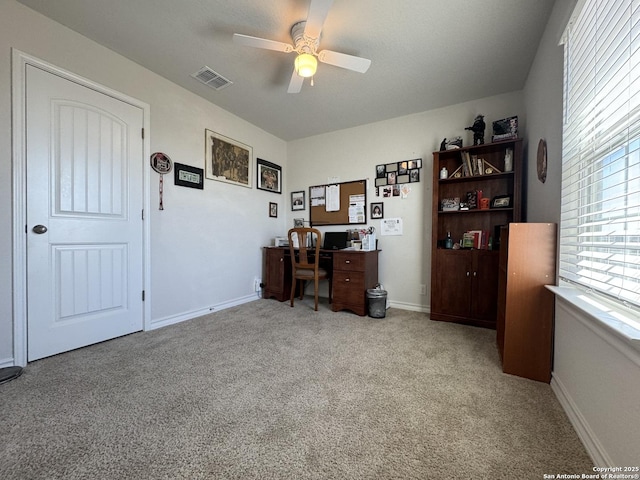 carpeted office featuring ceiling fan