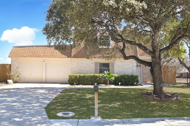 view of front of house featuring a garage and a front lawn