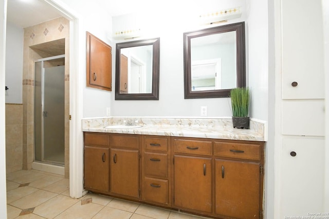 bathroom featuring vanity, tile patterned flooring, and walk in shower