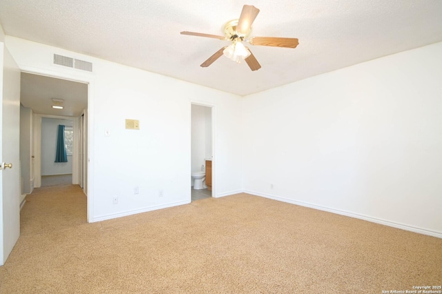 spare room with light carpet, a textured ceiling, and ceiling fan