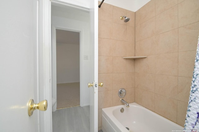 bathroom with wood-type flooring and shower / bath combination with curtain