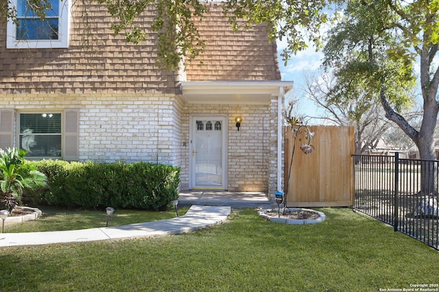 doorway to property with a lawn