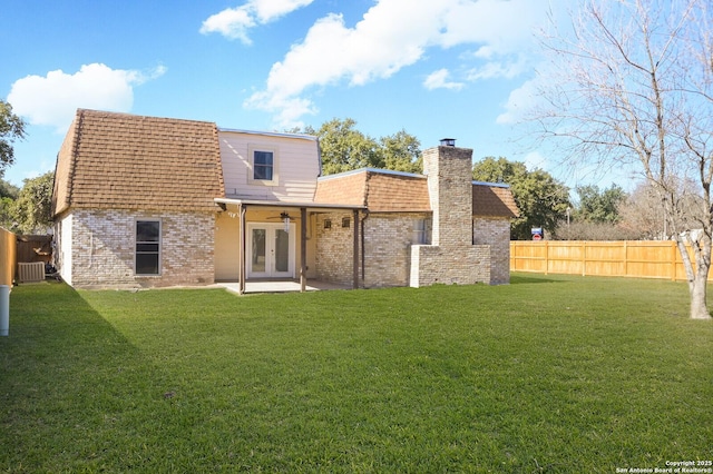 back of house with central AC unit, a lawn, ceiling fan, and a patio area