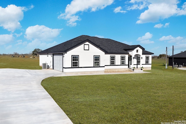 view of front of house with a garage, a front lawn, and central air condition unit