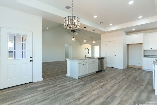 kitchen with pendant lighting, white cabinetry, sink, a kitchen island with sink, and stainless steel dishwasher