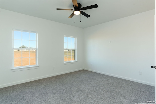 empty room with ceiling fan and carpet flooring