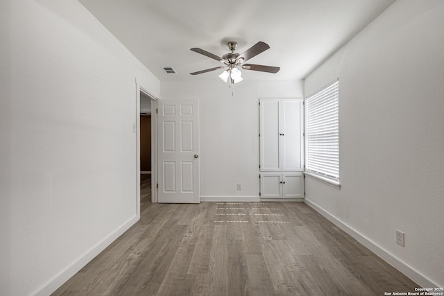 unfurnished bedroom featuring hardwood / wood-style flooring and ceiling fan