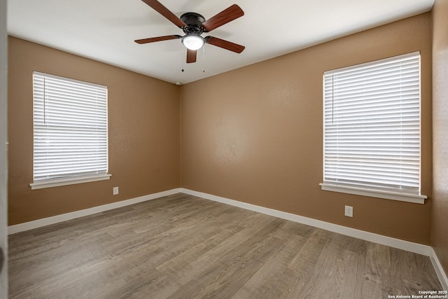 unfurnished room with ceiling fan and light hardwood / wood-style floors