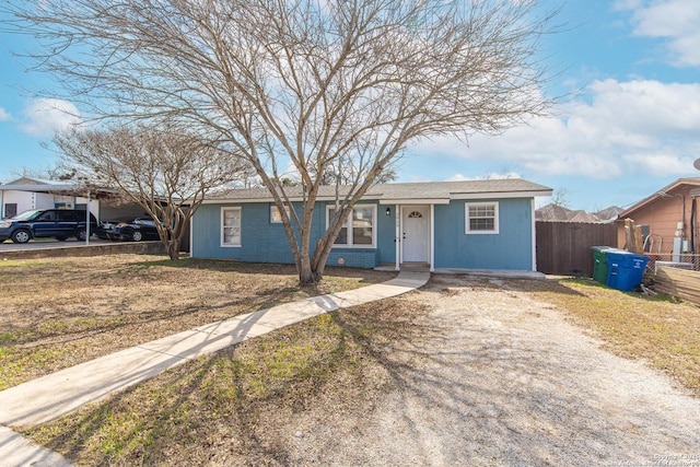 single story home featuring a front lawn and a carport