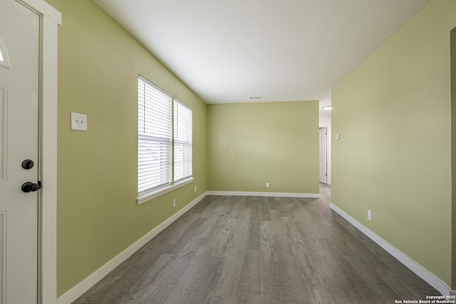 empty room with hardwood / wood-style flooring