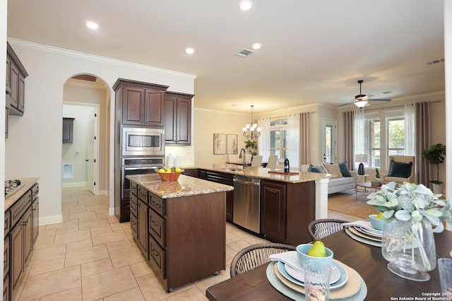 kitchen featuring a kitchen island, appliances with stainless steel finishes, pendant lighting, and kitchen peninsula