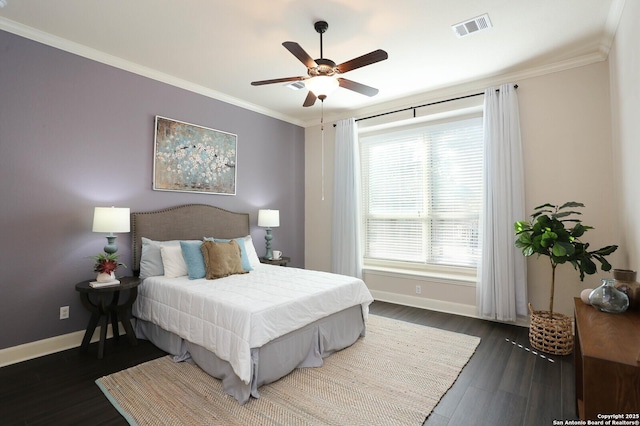 bedroom featuring dark hardwood / wood-style flooring, ornamental molding, and ceiling fan