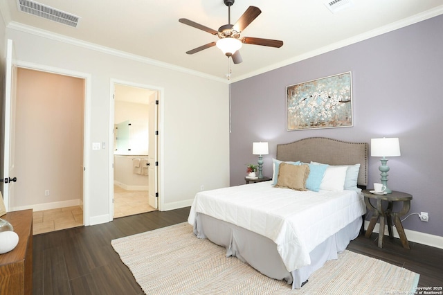 bedroom featuring dark wood-type flooring, ceiling fan, connected bathroom, and crown molding