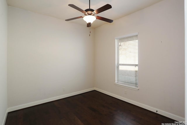 empty room featuring dark wood-type flooring and ceiling fan